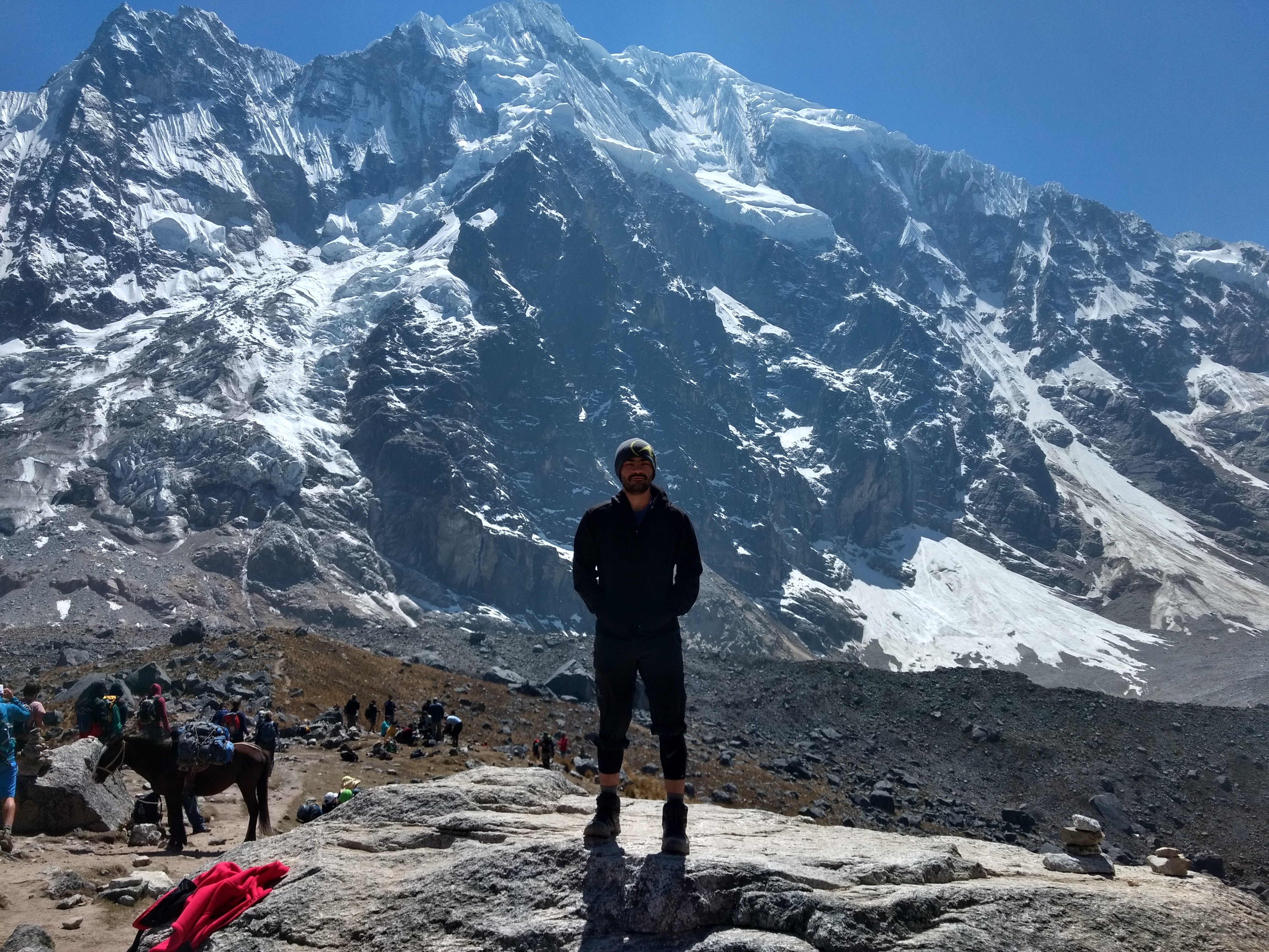 Jesus Marini Parissi standing before a high snow-covered mountain range
